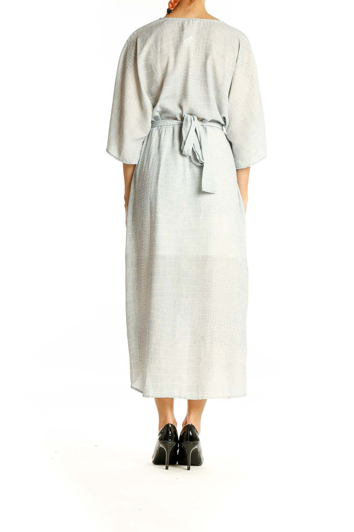 Back view of light gray wrap midi dress showing tie detail