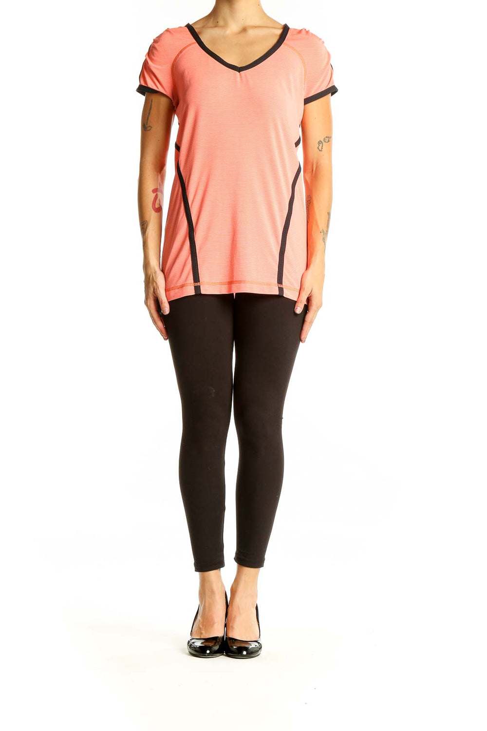 Front view of coral Lululemon athletic top with V-neck and black trim