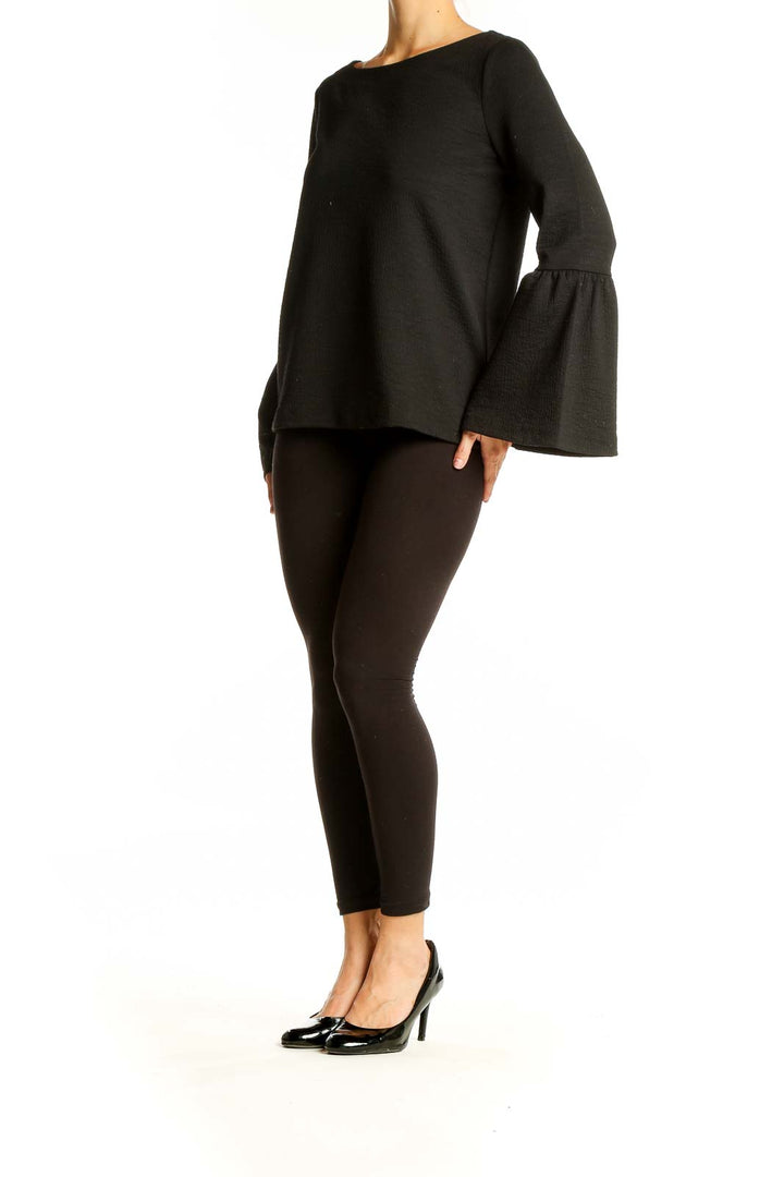 Front view of Ann Taylor Petites black bell sleeve top with boat neckline