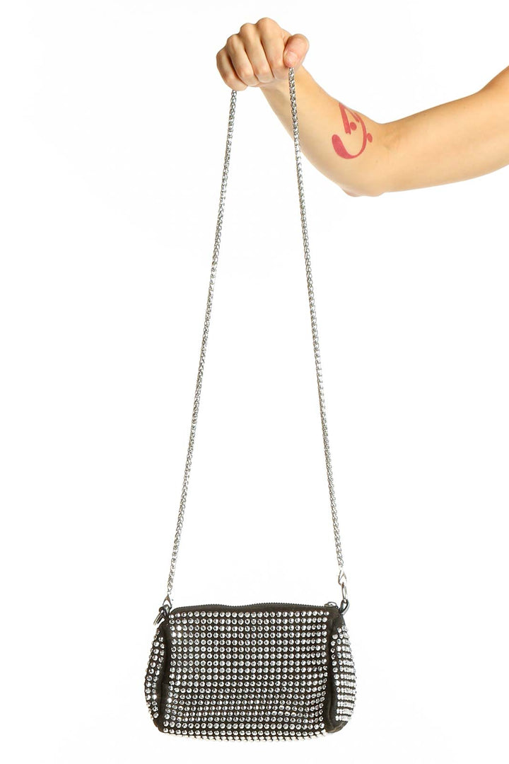 Front view of SilkRoll black studded crossbody bag with chain strap