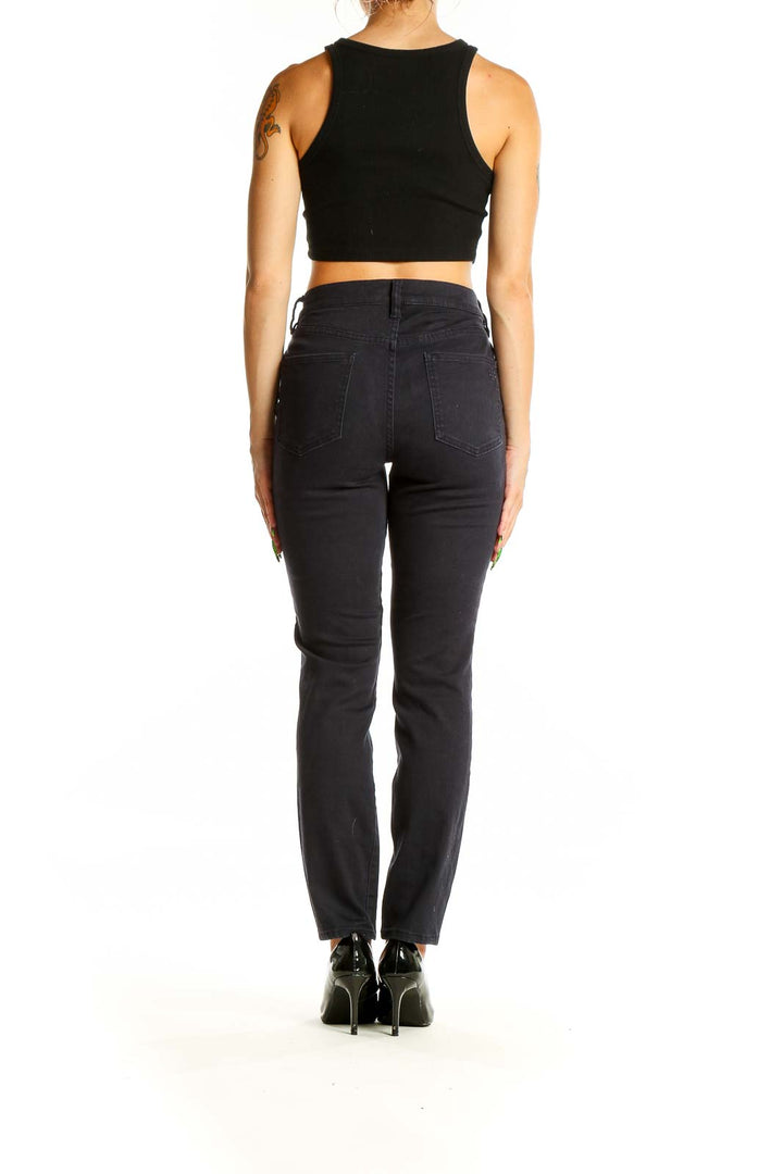 Back view of Tory Burch black straight-leg jeans on model