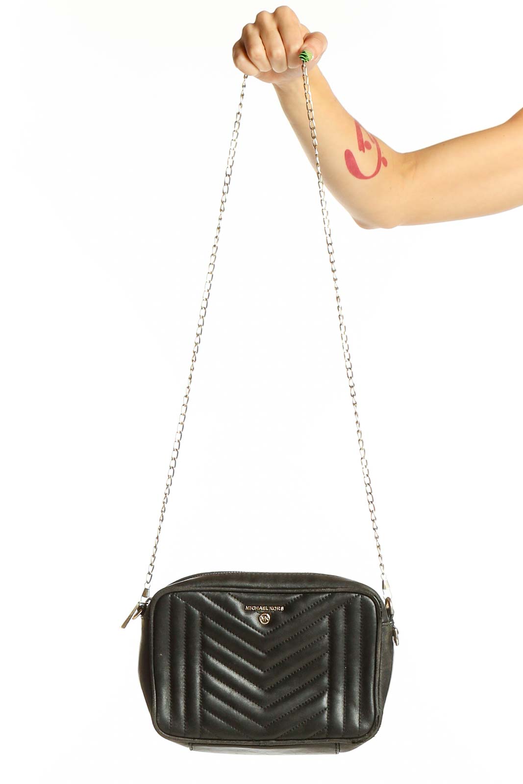 Front view of Michael Kors black quilted leather crossbody bag with silver chain strap