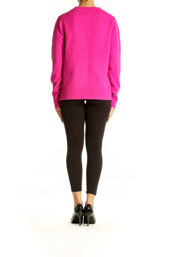 Back view of hot pink J.Crew crew neck sweater on model with black pants