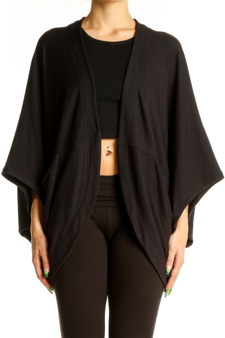 Front view of black Athleta knit cardigan with flowy silhouette and kimono sleeves