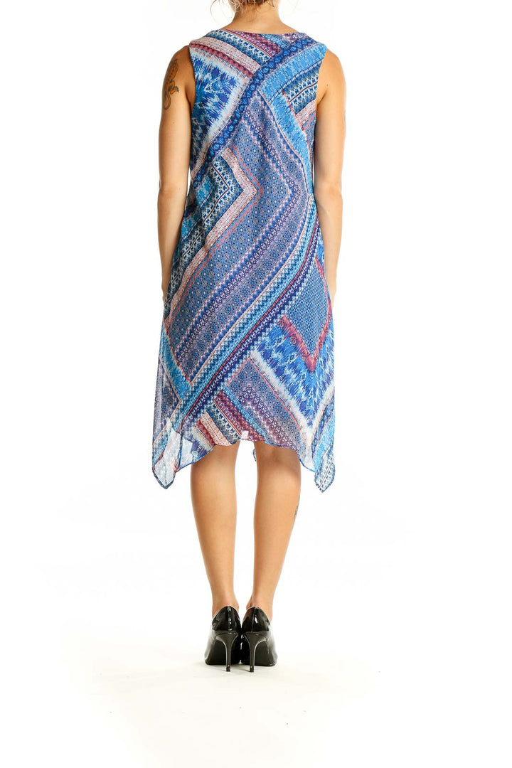 Back view of SANDRA DARREN blue multicolor patterned sleeveless dress with handkerchief hem