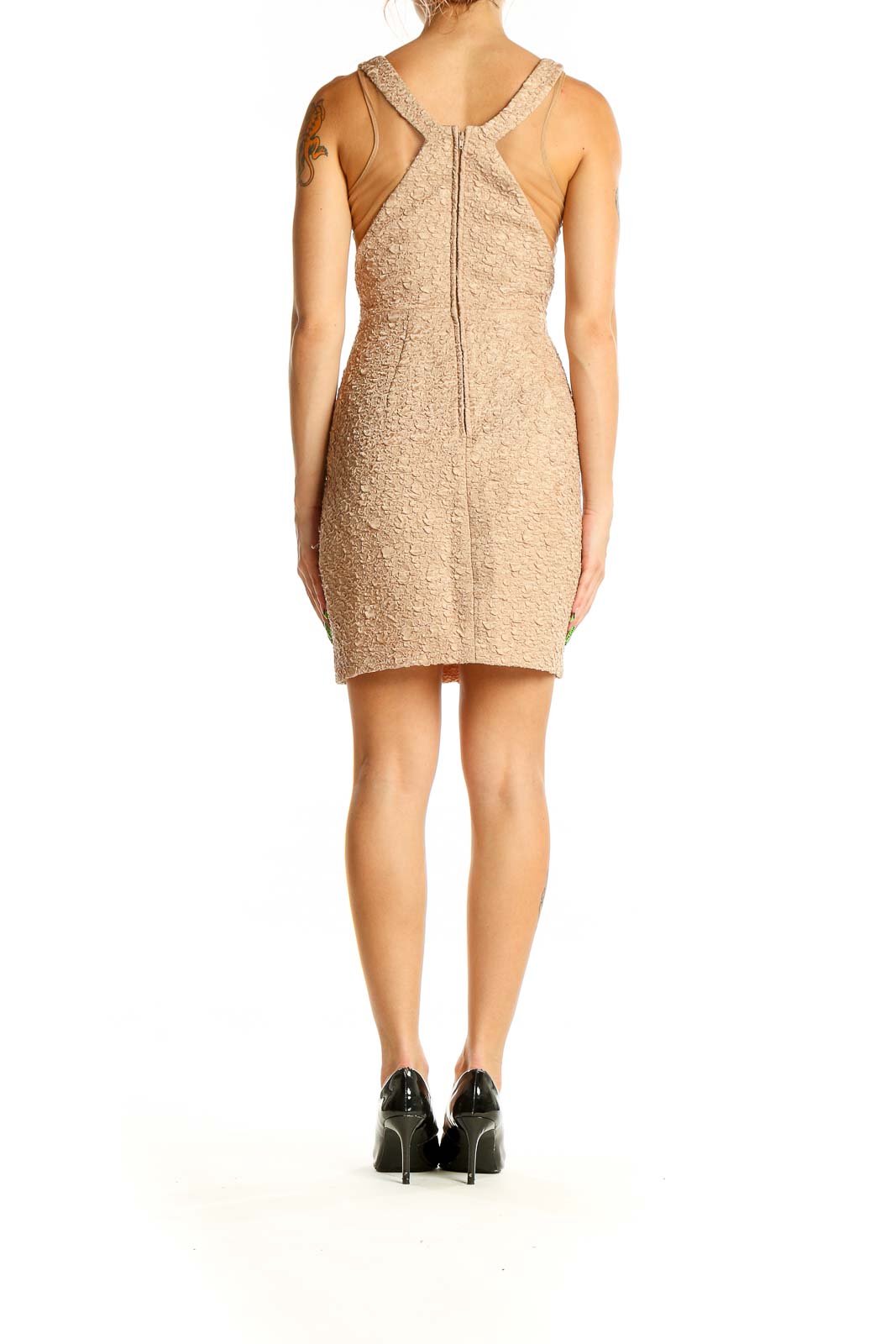 Back view of beige textured bodycon mini dress with racerback design