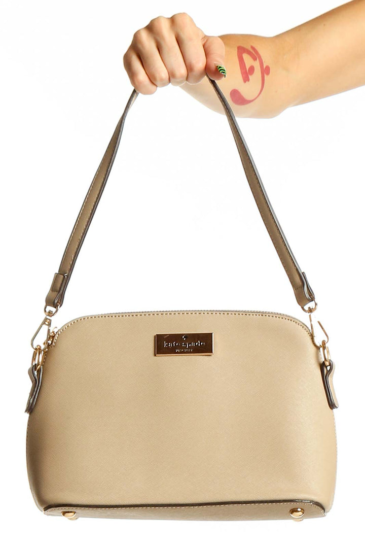 Front view of Kate Spade beige crossbody bag with gold hardware