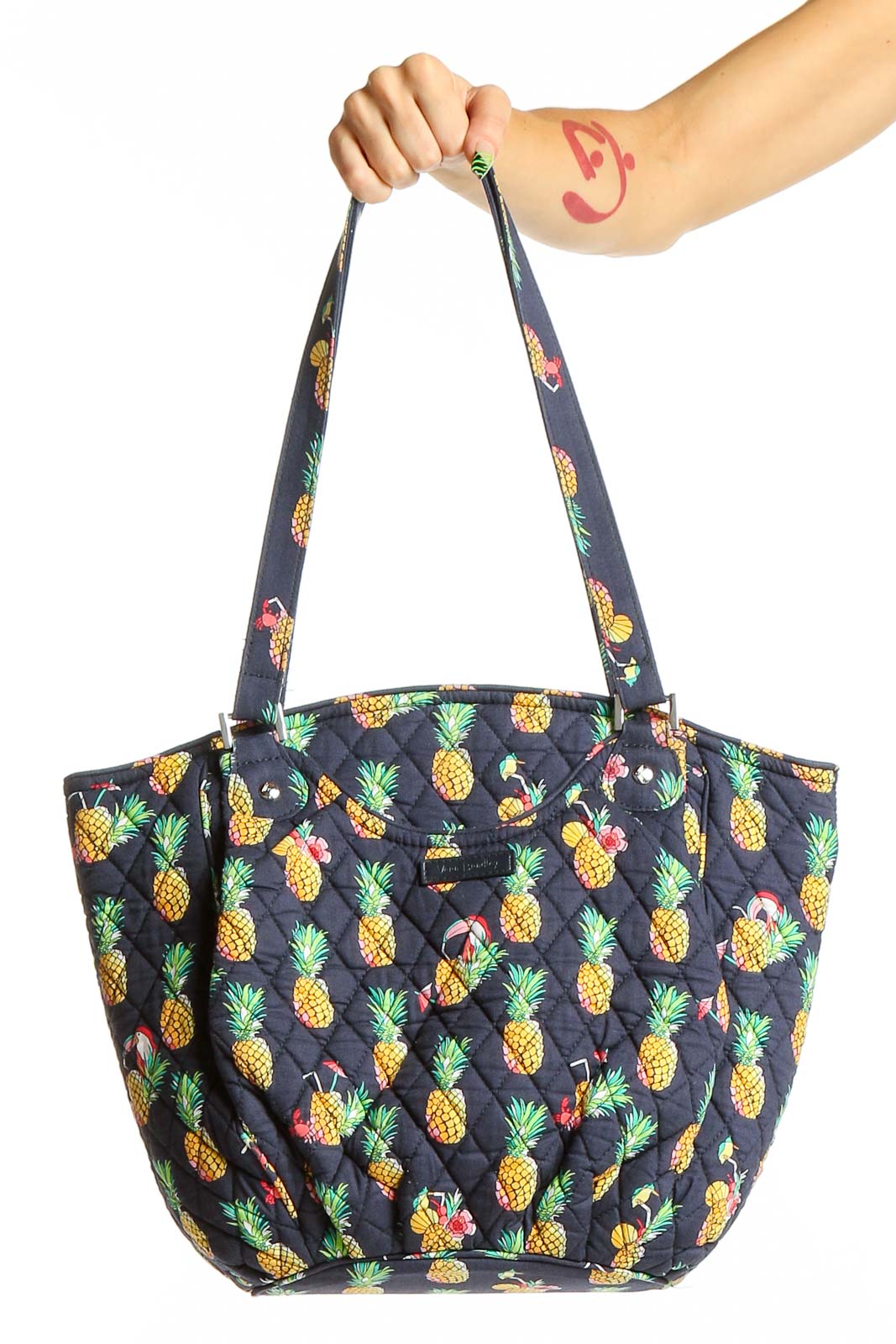 Front view of Vera Bradley navy quilted tote bag with pineapple print