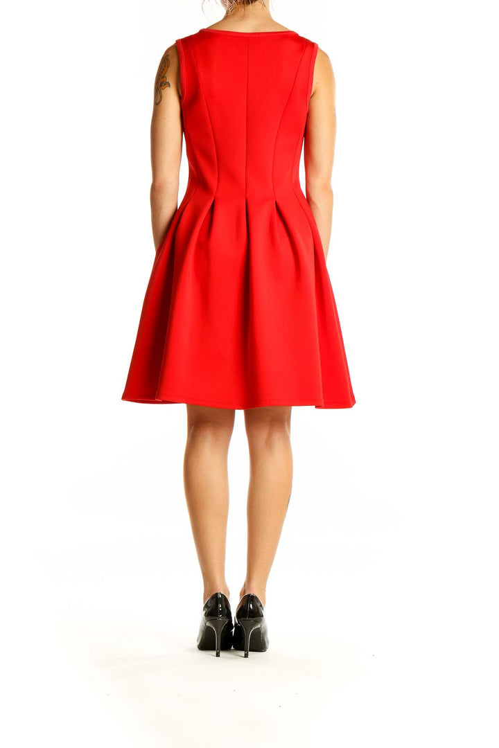 Back view of red sleeveless fit and flare dress with pleated skirt