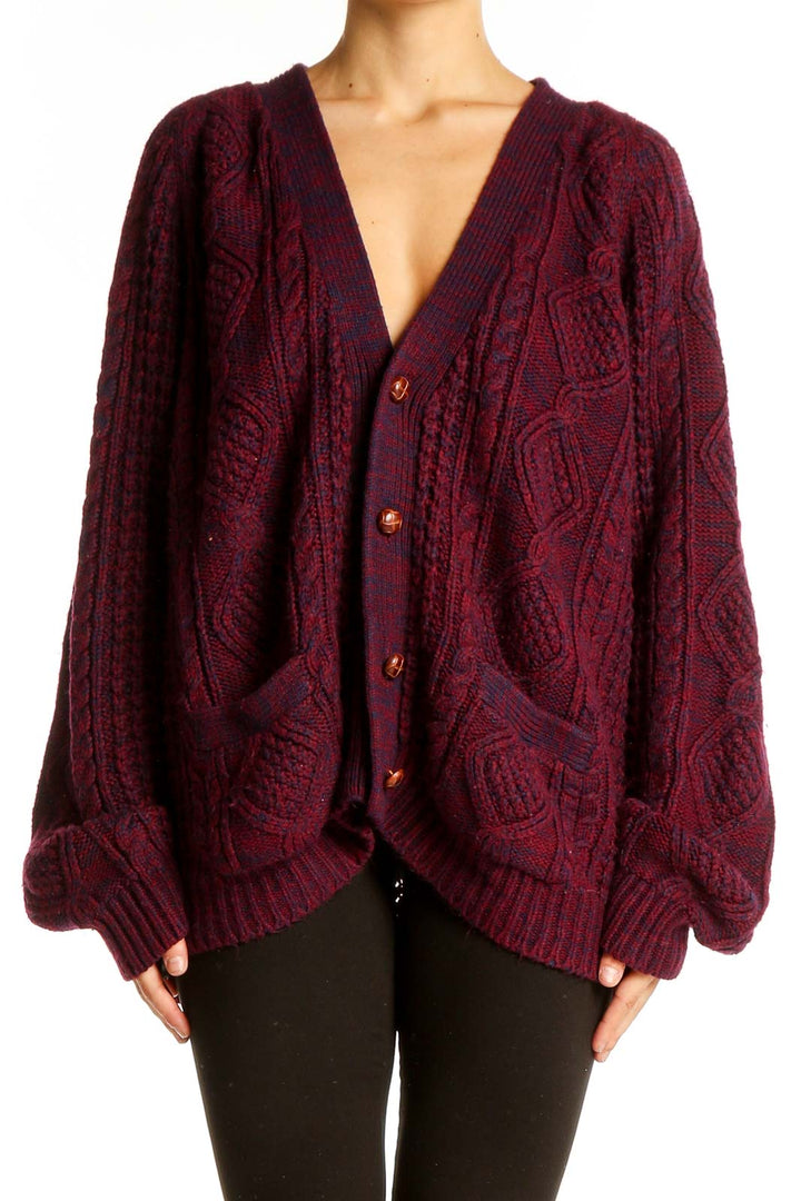 Front view of burgundy oversized cable knit cardigan with V-neck and button closure