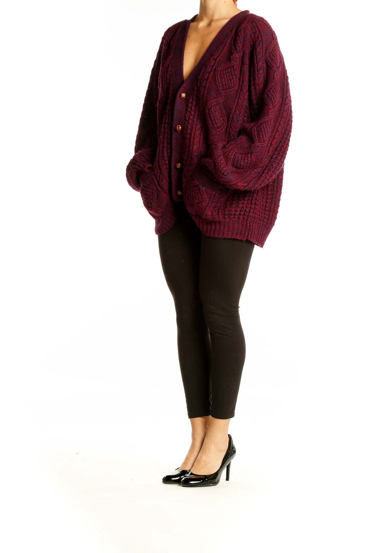 Front view of burgundy oversized cable knit cardigan with V-neck and button closure