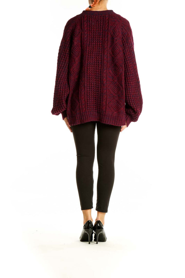 Back view of burgundy oversized cable knit cardigan showing intricate knit pattern