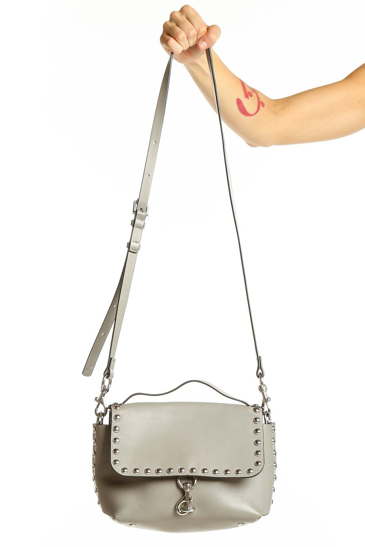 Front view of Rebecca Minkoff gray studded leather crossbody bag