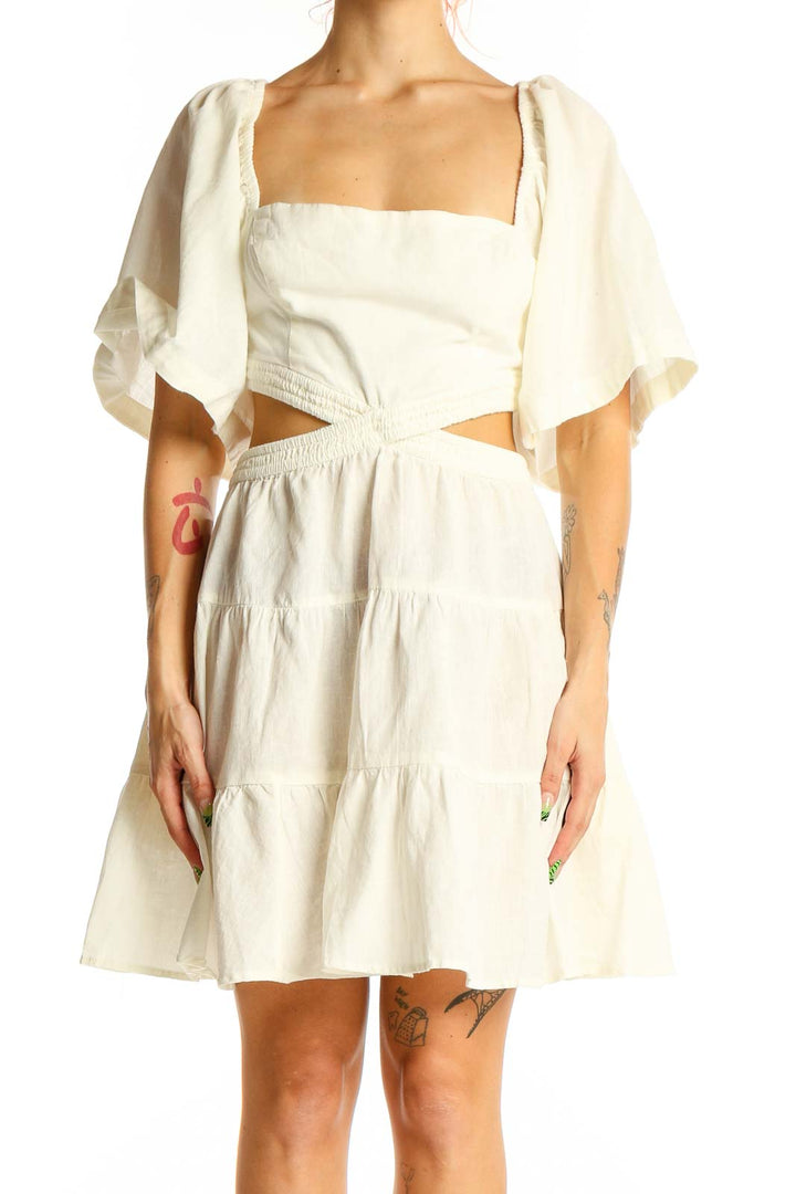 Front view of Free People Ivory Cutout Tiered Mini Dress with puff sleeves