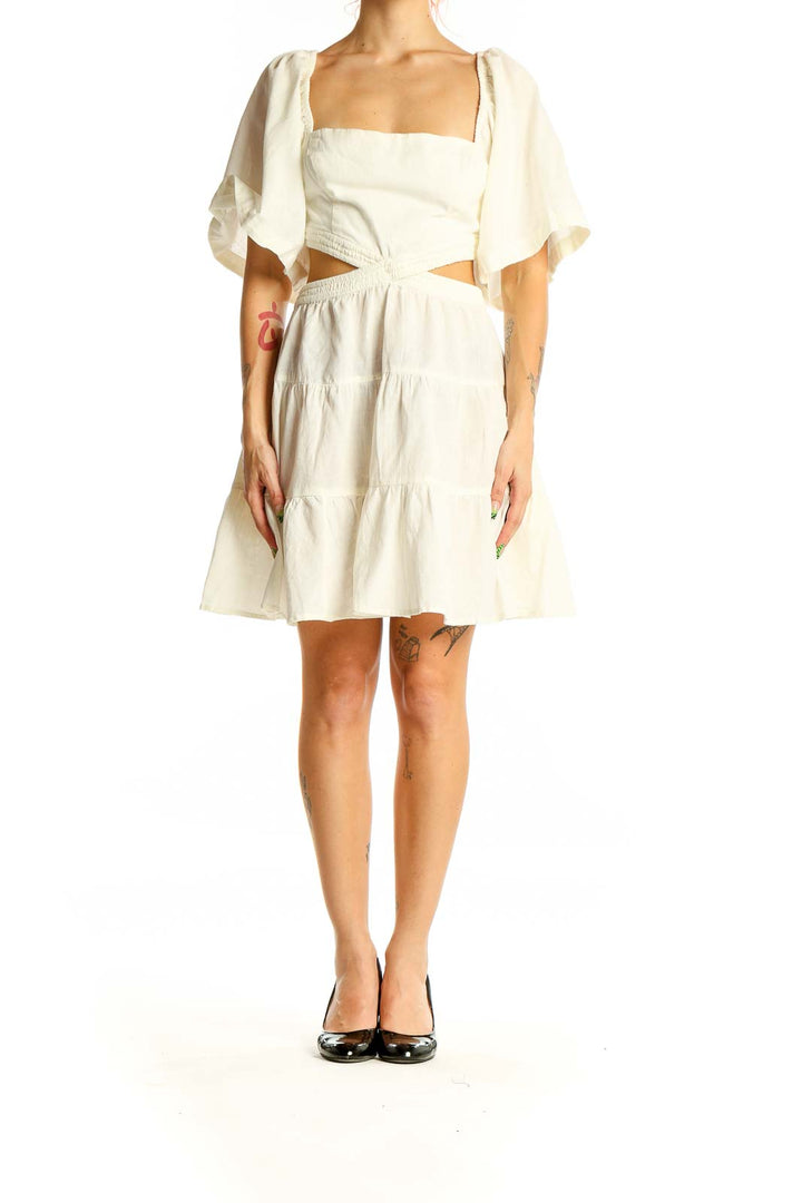 Front view of Free People Ivory Cutout Tiered Mini Dress with puff sleeves