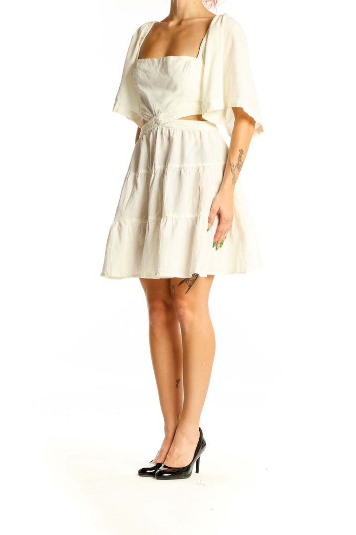 Front view of Free People Ivory Cutout Tiered Mini Dress with puff sleeves