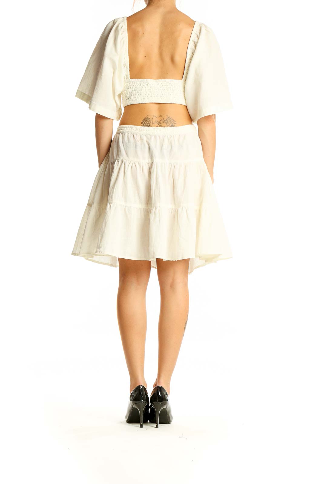 Back view of Free People Ivory Cutout Tiered Mini Dress showing open back design