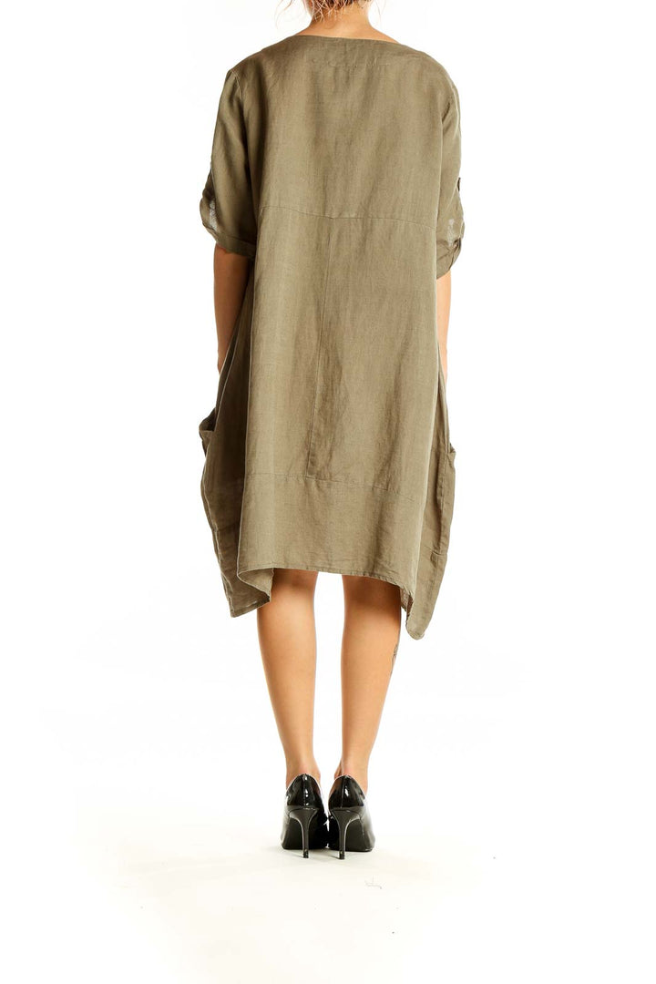 Back view of olive Kaktus linen-cotton dress showing relaxed silhouette and asymmetrical hem