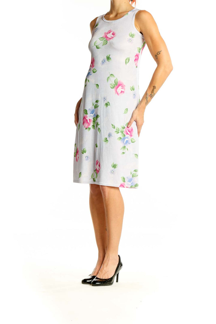 Front view of white sleeveless midi dress with pink and blue floral print