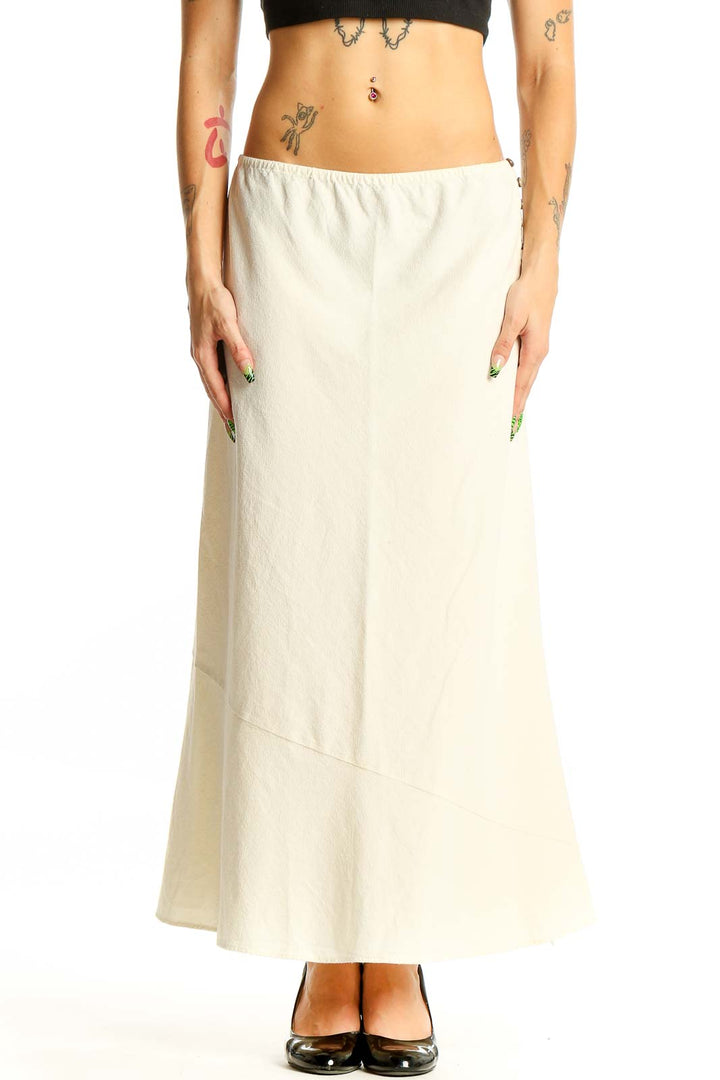 Front view of Free People cream cotton maxi skirt with A-line silhouette