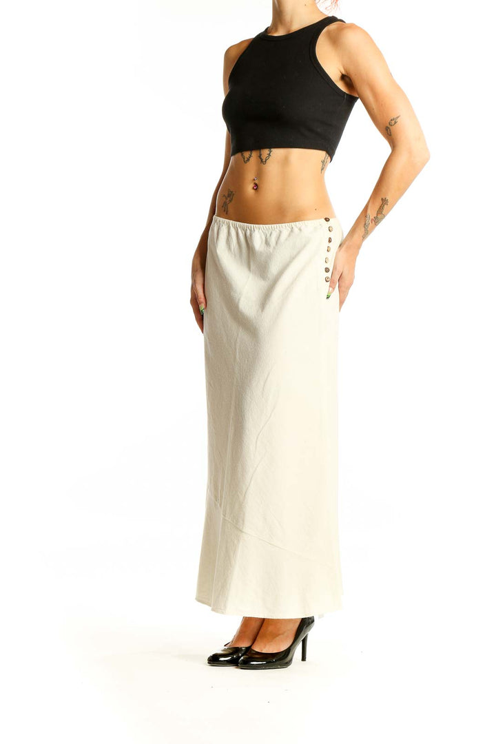 Front view of Free People cream cotton maxi skirt with A-line silhouette