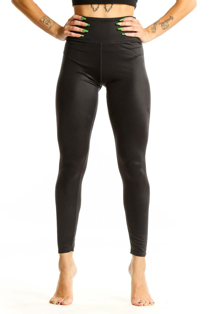 Front view of black high-waisted SOULCYCLE leggings on model