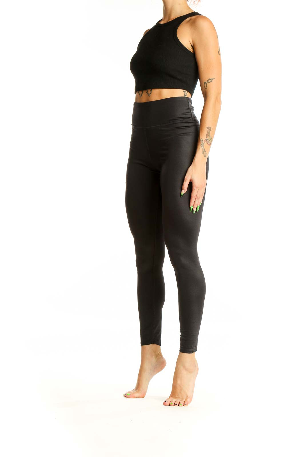 Front view of black high-waisted SOULCYCLE leggings on model