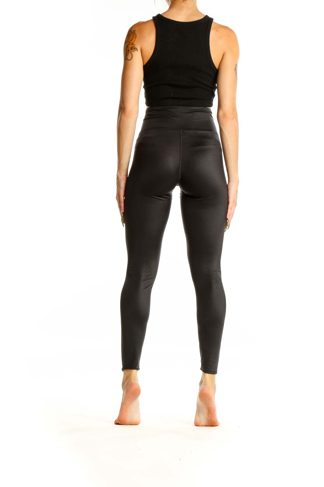 Back view of black high-waisted SOULCYCLE leggings on model