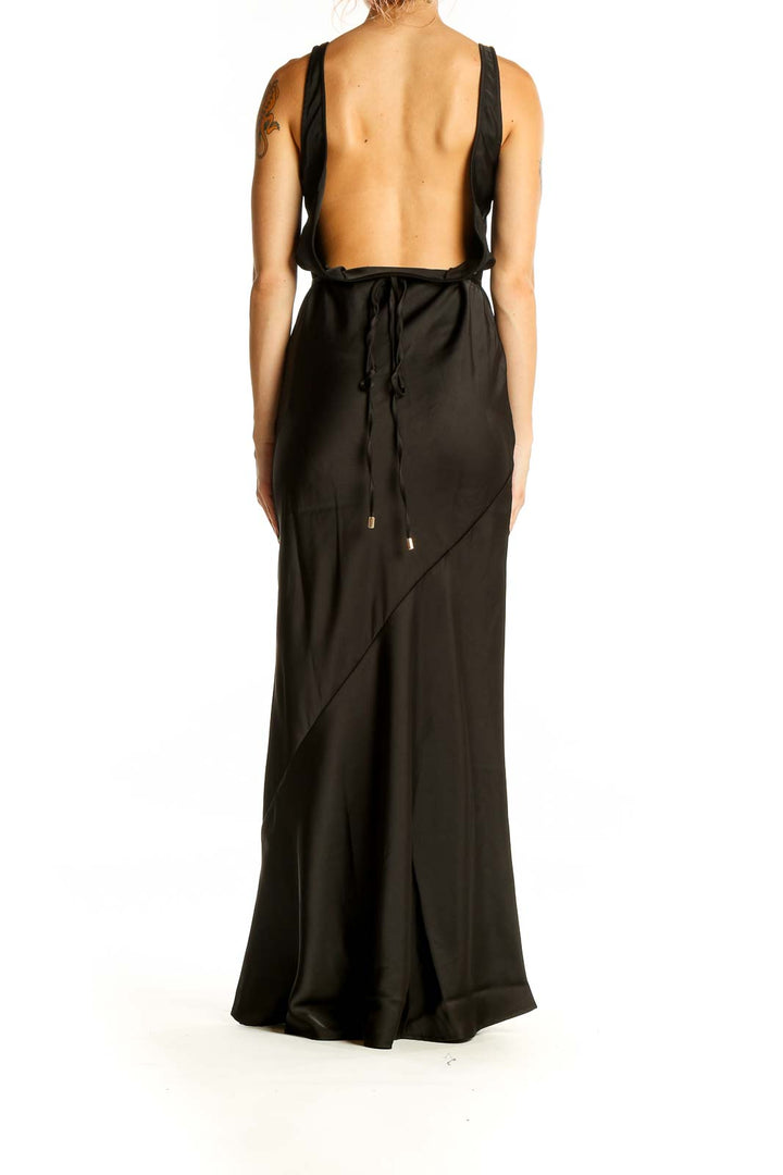 Back view of black maxi dress showing open back design with tie closure