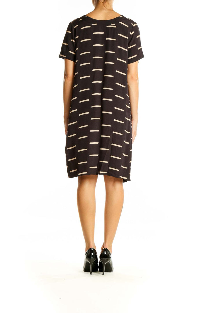 Back view of SilkRoll black striped shift dress showing pattern continuity