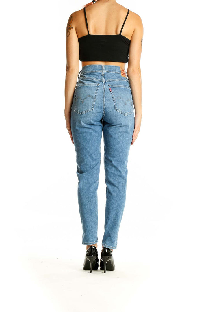 Back view of Levi's light blue high-waisted slim fit jeans on model