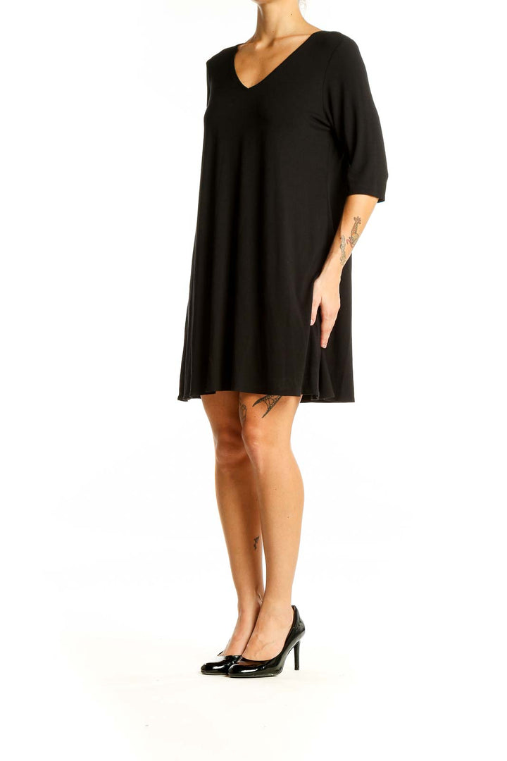 Front view of Eileen Fisher black V-neck flowy midi dress