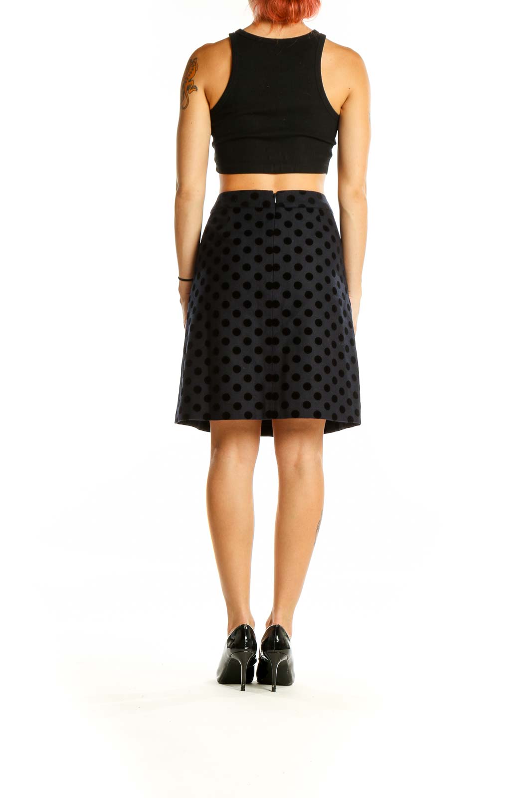 Back view of Boden black polka dot A-line knee-length skirt on model