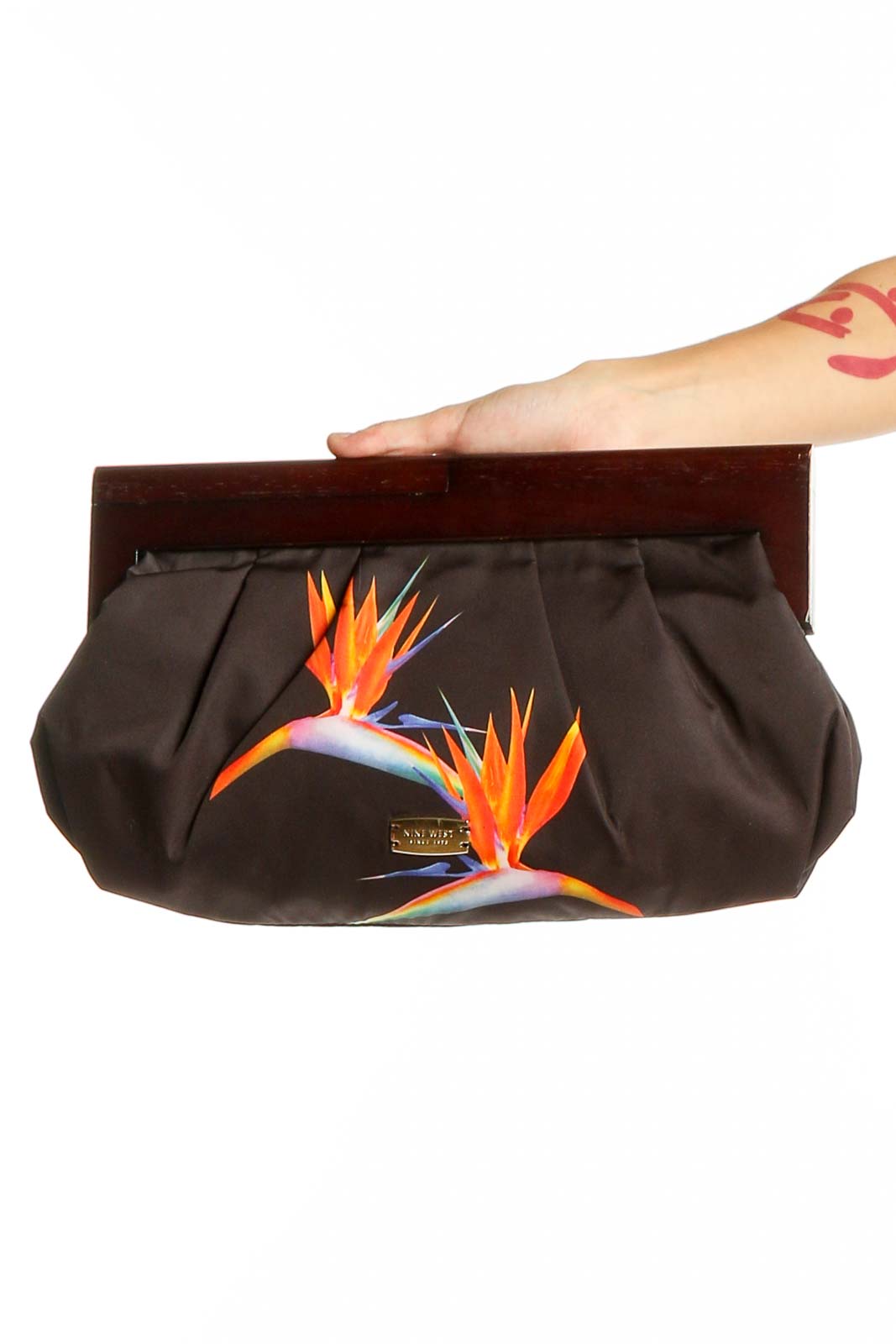 Front view of Nine West brown clutch with colorful floral print and wooden frame