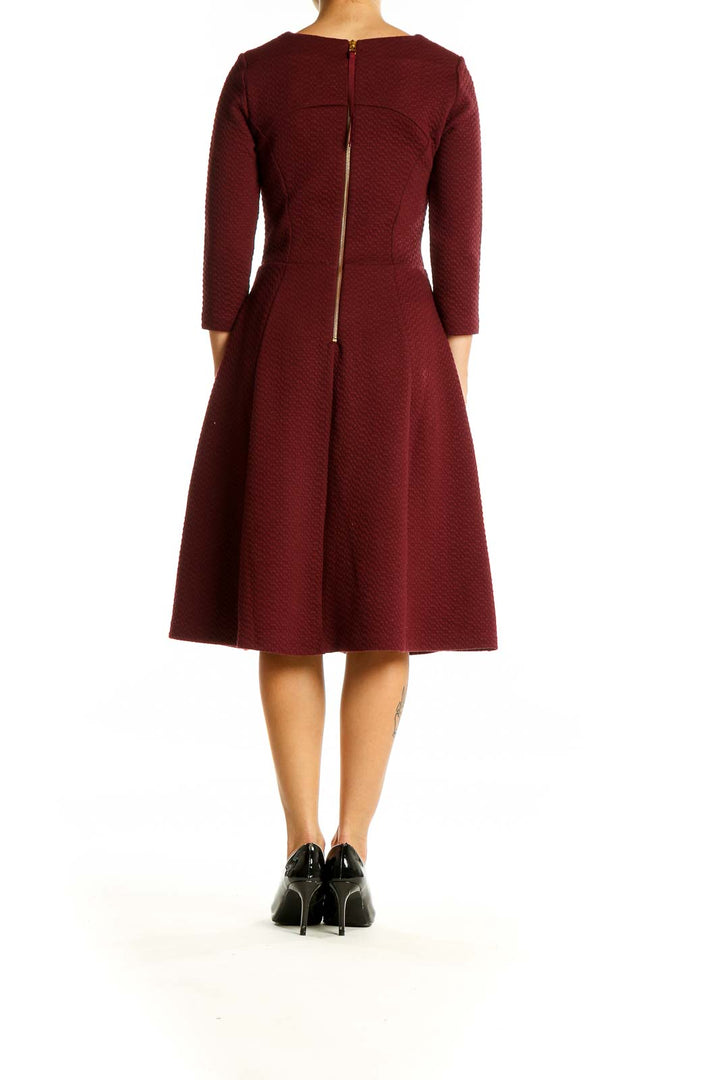 Back view of burgundy Boden fit-and-flare midi dress showing zipper closure