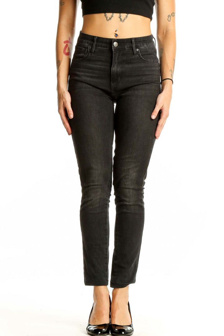 Front view of Levi's black high-waisted slim fit jeans on model