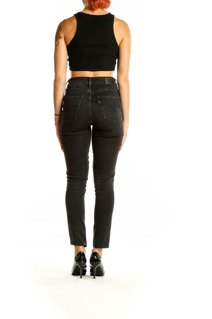 Back view of Levi's black high-waisted slim fit jeans on model