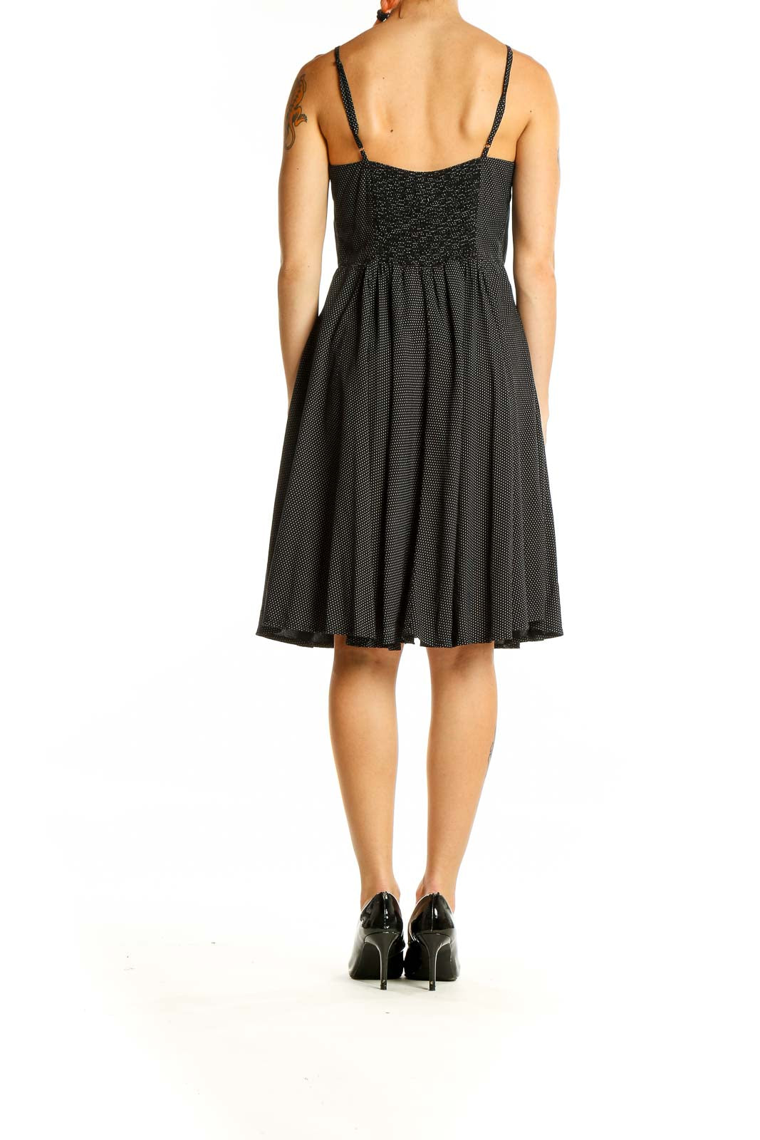 Back view of Gap black polka dot sundress showing smocked panel