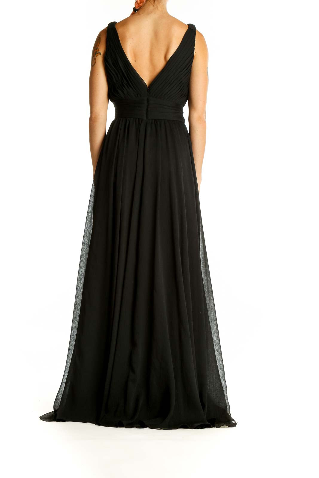 Back view of black V-neck chiffon evening gown showing open back design