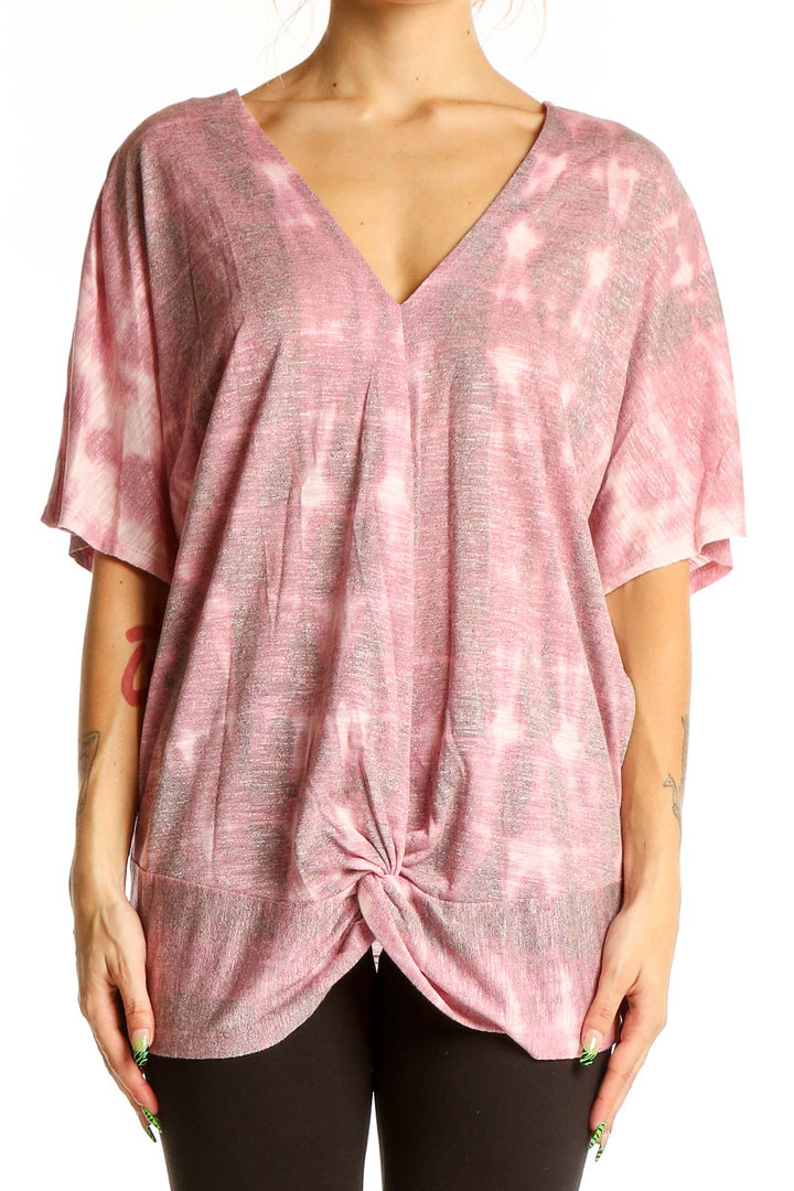 Front view of pink tie-dye V-neck oversized top with knotted hem