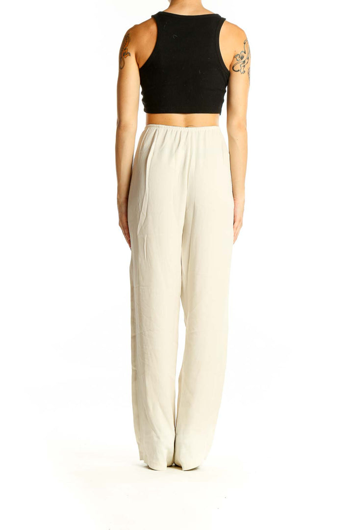 Back view of Eileen Fisher cream wide-leg flowy pants on model