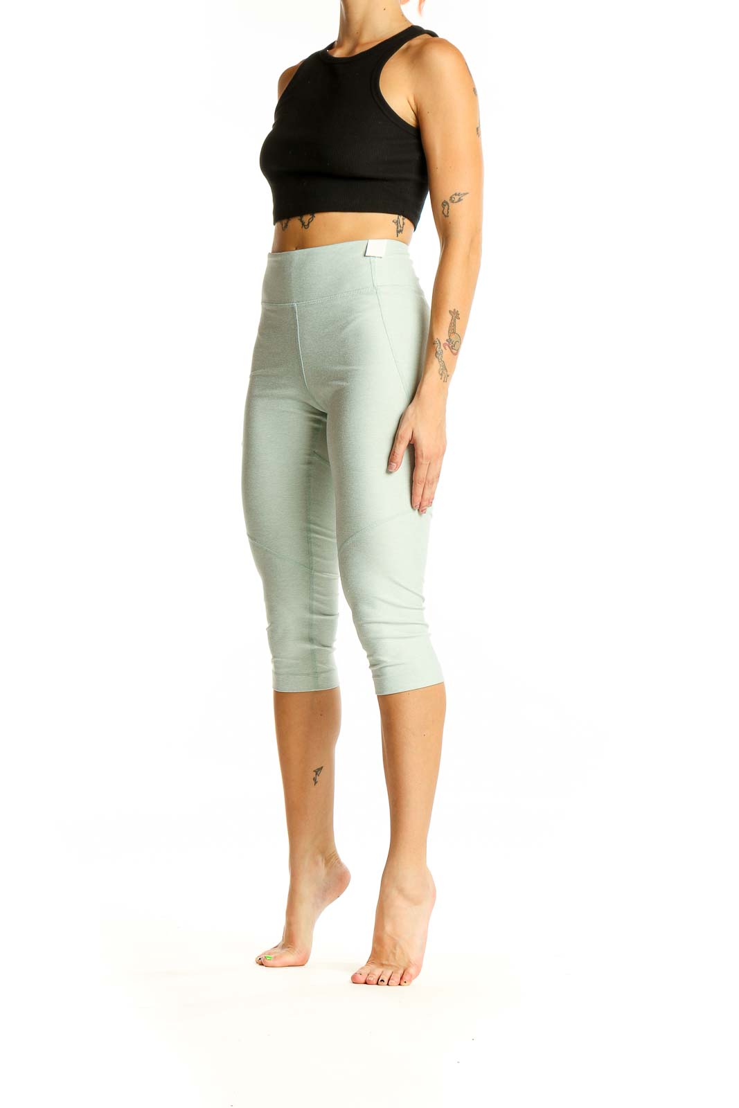 Front view of mint green high-waisted capri leggings from Outdoor Voices