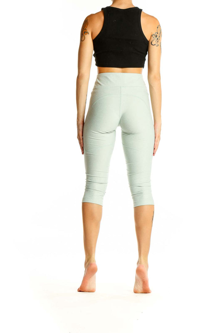 Back view of mint green high-waisted capri leggings from Outdoor Voices