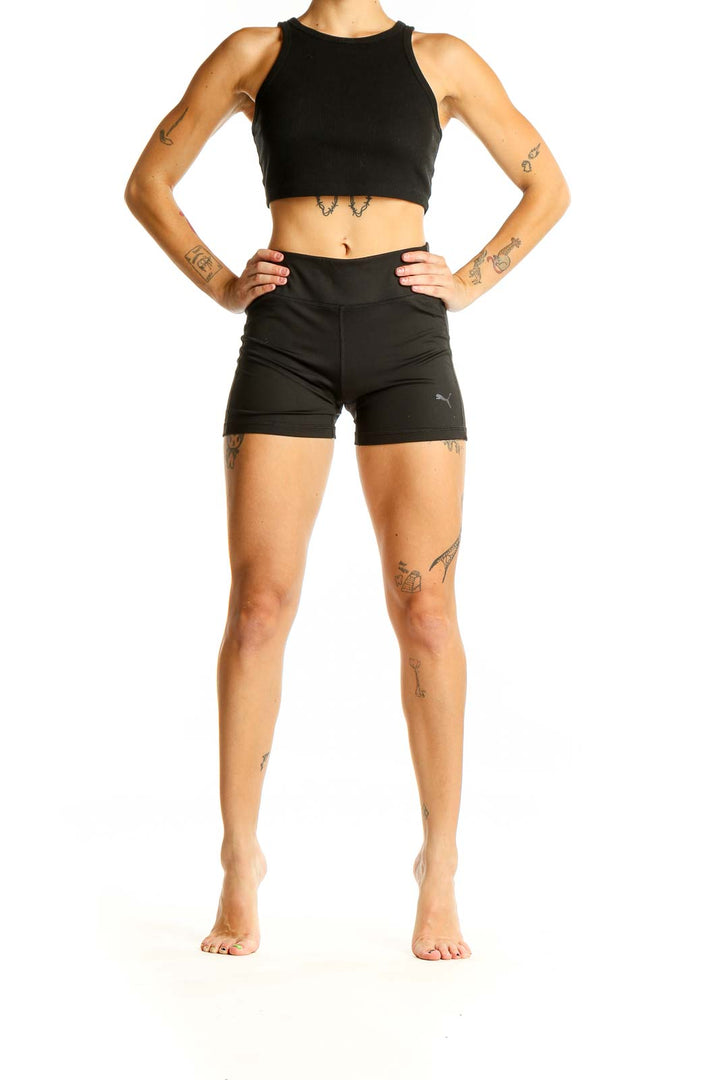 Front view of black Puma high-waisted athletic shorts