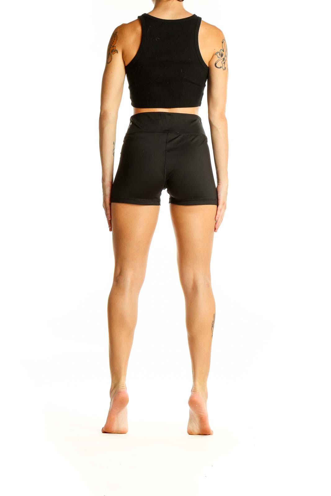 Back view of black Puma high-waisted athletic shorts on model