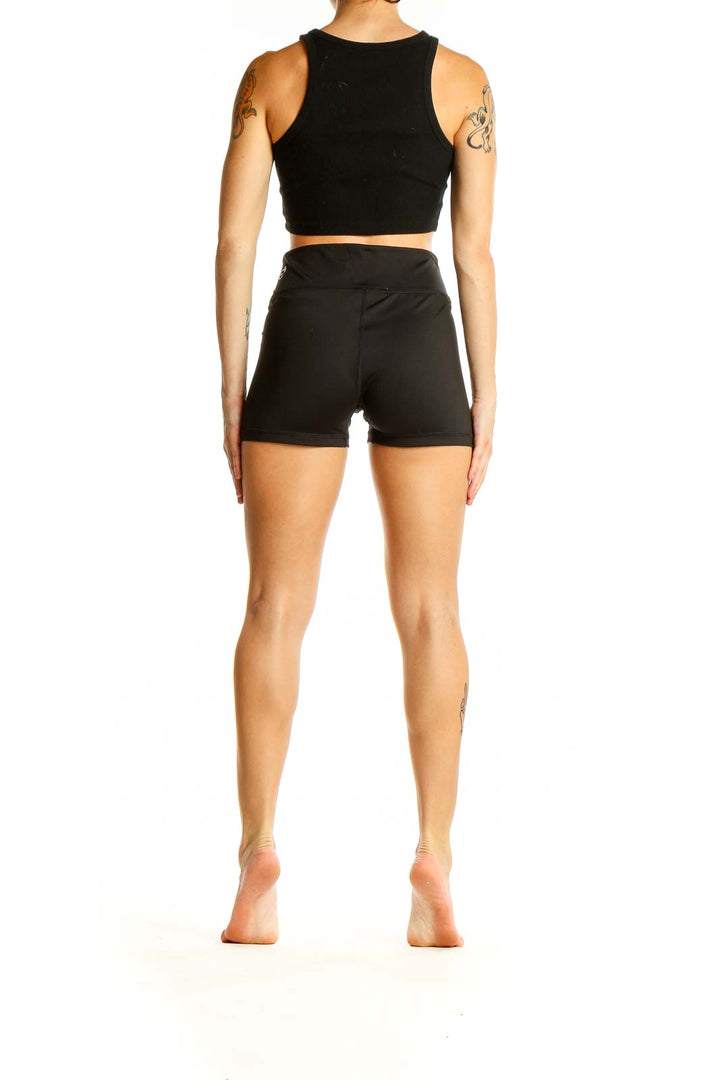 Back view of black Puma high-waisted athletic shorts on model