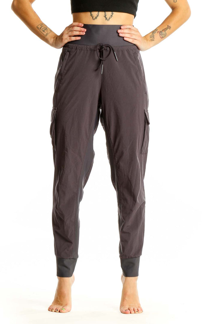 Front view of Athleta gray high-waisted cargo joggers with drawstring waist