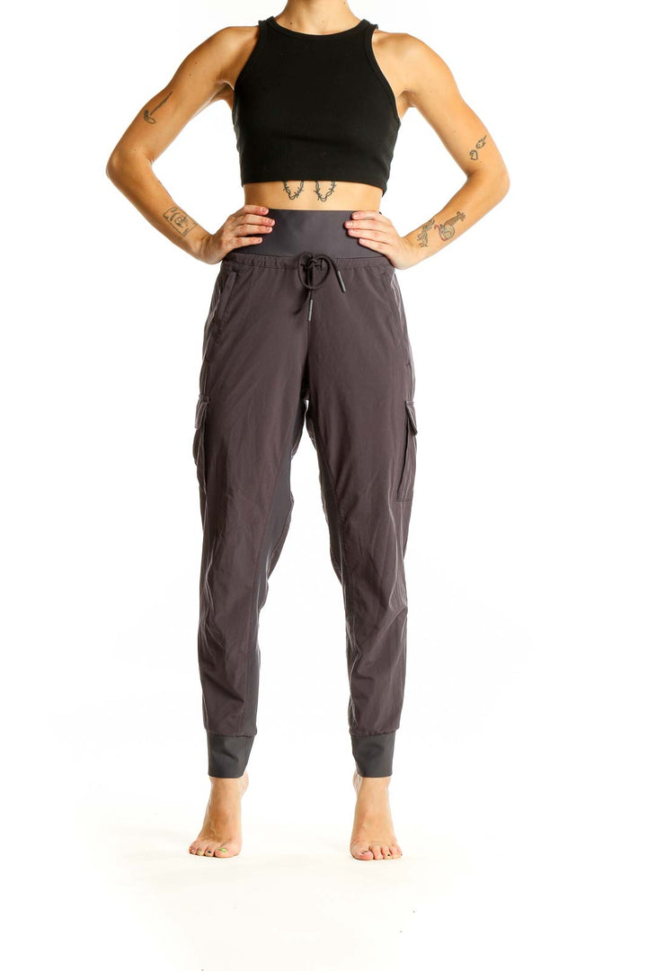 Front view of Athleta gray high-waisted cargo joggers with drawstring waist