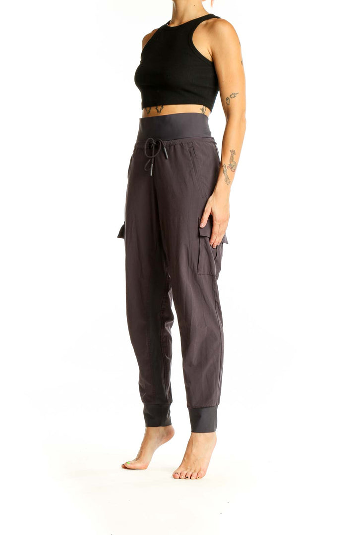 Front view of Athleta gray high-waisted cargo joggers with drawstring waist