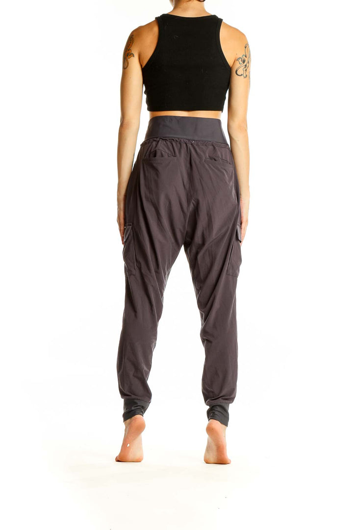 Back view of Athleta gray high-waisted cargo joggers showing tapered leg and fit